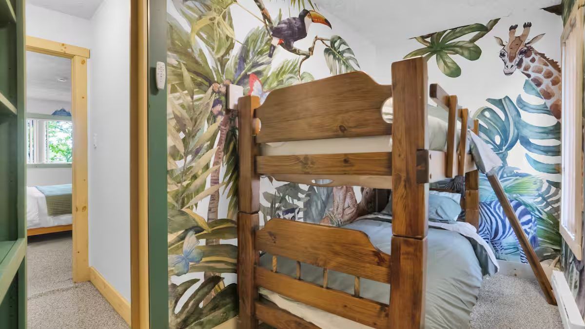 Bunk beds and jungle mural in the hidden kids' room
